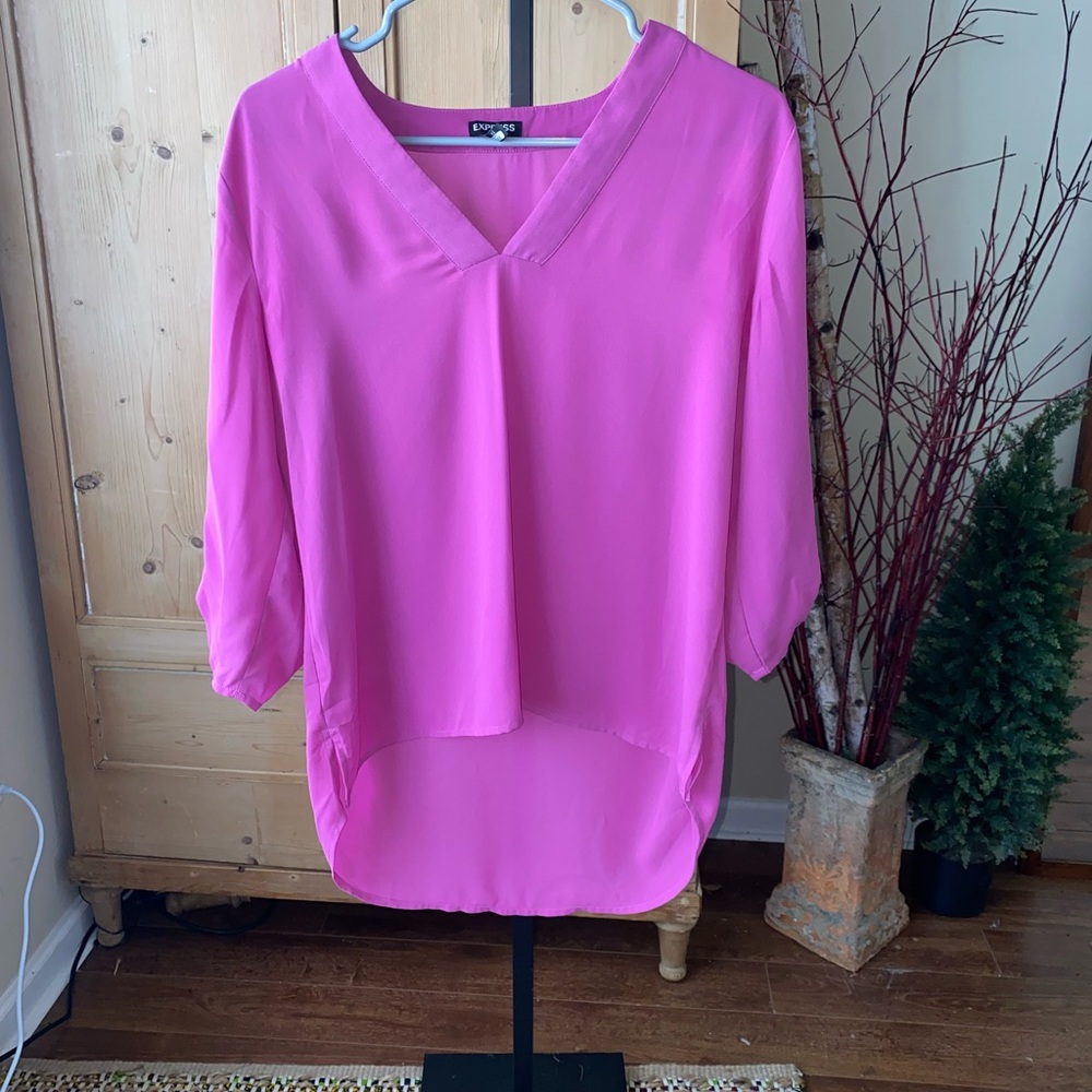 Women’s polyester fuchsia high-low top with quarter sleeves.
